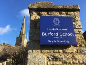 a plaque outside of Burford school on a wall